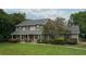 Traditional two-story home with a well-manicured front yard and mature trees providing shade at 104 Forest Point Ln, Longwood, FL 32779