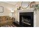 Elegant fireplace with black surround and decorative mantel, enhancing the room's traditional charm at 104 Forest Point Ln, Longwood, FL 32779