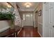 Welcoming foyer with hardwood floors, staircase, and a decorative flower arrangement at 104 Forest Point Ln, Longwood, FL 32779