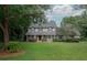 Charming two-story home features a well-maintained lawn and a welcoming front porch at 104 Forest Point Ln, Longwood, FL 32779
