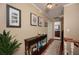 Hallway with a console table, artwork, wood floors, and a view of the bathroom at 104 Forest Point Ln, Longwood, FL 32779
