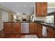 Spacious kitchen features dark countertops, wood cabinets, and stainless steel appliances at 104 Forest Point Ln, Longwood, FL 32779