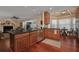View of kitchen with wooden cabinets, granite countertops, stainless steel appliances and hardwood floors at 104 Forest Point Ln, Longwood, FL 32779