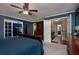 Spacious primary bedroom featuring a ceiling fan, closet, and a connecting hallway with a bathroom at 104 Forest Point Ln, Longwood, FL 32779