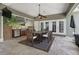 Covered outdoor dining area with built-in grill, television and ceiling fan at 104 Forest Point Ln, Longwood, FL 32779