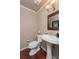 A cozy powder room featuring a pedestal sink, toilet, and classic design at 104 Forest Point Ln, Longwood, FL 32779