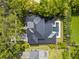 Aerial view showcasing the home's unique roofline and a private backyard oasis featuring a modern pool and manicured landscaping at 1211 Munster St, Orlando, FL 32803
