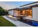 Backyard oasis featuring a modern pool, fire feature, and an outdoor seating area with a grill at 1211 Munster St, Orlando, FL 32803