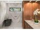 Modern bathroom features a marble shower, a black freestanding tub, and walnut cabinets at 1211 Munster St, Orlando, FL 32803