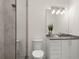 Bright bathroom featuring a glass shower, sleek fixtures, and a modern vanity with stylish lighting at 1211 Munster St, Orlando, FL 32803