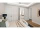 Bright bedroom showcasing a bed with soft textures, opens to bathroom, and hardwood floors at 1211 Munster St, Orlando, FL 32803