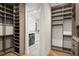 Custom closet design featuring built-in shelving and wooden floors for optimal organization and aesthetic appeal at 1211 Munster St, Orlando, FL 32803