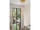 View of a chandelier hanging in the stairwell of the home with a view of the green yard at 1211 Munster St, Orlando, FL 32803