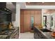 Close-up of a modern kitchen, featuring sleek appliances, custom cabinetry, and a stylish wine fridge at 1211 Munster St, Orlando, FL 32803