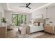 Bright main bedroom with large windows, a ceiling fan, neutral color scheme, and wood floors at 1211 Munster St, Orlando, FL 32803