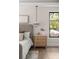 Close-up of a nightstand in the main bedroom featuring decor and an oversized window at 1211 Munster St, Orlando, FL 32803