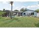 Expansive backyard showcasing a screened pool area, hot tub, and ample green space for leisure and recreation at 1360 Gladiolas Dr, Winter Park, FL 32792
