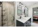 Bathroom boasts a glass enclosed shower and a double vanity with black fixtures and modern lighting at 1360 Gladiolas Dr, Winter Park, FL 32792