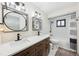 Modern bathroom with dual sinks, black fixtures, and tub-shower with a white subway tile surround at 1360 Gladiolas Dr, Winter Park, FL 32792