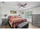 Bedroom with a large bed, ceiling fan, window, and matching furniture at 1360 Gladiolas Dr, Winter Park, FL 32792