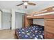 Bedroom with wood bunk beds, ceiling fan, and closet with ample storage at 1360 Gladiolas Dr, Winter Park, FL 32792