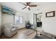 Bright bedroom provides a work space with a desk and chair, as well as a relaxing sitting area at 1360 Gladiolas Dr, Winter Park, FL 32792