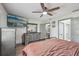 Spacious bedroom with a large bed, ceiling fan, TV, and matching furniture at 1360 Gladiolas Dr, Winter Park, FL 32792