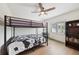 Bright bedroom with black bunk beds, ceiling fan, and window with natural light at 1360 Gladiolas Dr, Winter Park, FL 32792