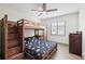 Bedroom with wood bunk beds, ceiling fan, and window with natural light at 1360 Gladiolas Dr, Winter Park, FL 32792