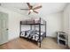 Spacious bedroom with black bunk beds, ceiling fan, and a bright interior at 1360 Gladiolas Dr, Winter Park, FL 32792