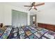 Bedroom showcases a bright interior, a ceiling fan, and an adjacent dresser at 1360 Gladiolas Dr, Winter Park, FL 32792