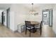 Bright dining room featuring a modern chandelier and access to the bathroom at 1360 Gladiolas Dr, Winter Park, FL 32792