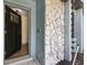Open entryway featuring a modern door, stone accents, and a glimpse into the bright, inviting interior at 1360 Gladiolas Dr, Winter Park, FL 32792