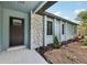 Inviting entrance with stone accents, a modern door, and fresh landscaping, creating curb appeal at 1360 Gladiolas Dr, Winter Park, FL 32792