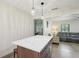 Kitchen island with quartz countertop and view into the living area at 1360 Gladiolas Dr, Winter Park, FL 32792