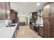 Bright kitchen featuring stainless steel appliances, dark cabinetry, and modern countertops at 1360 Gladiolas Dr, Winter Park, FL 32792