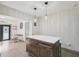 Kitchen island with white countertop, dark cabinets, and pendant lights above at 1360 Gladiolas Dr, Winter Park, FL 32792
