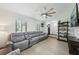 Spacious living room with ample seating, large windows, and hardwood flooring, perfect for relaxation at 1360 Gladiolas Dr, Winter Park, FL 32792
