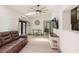 Bright and open living space with hardwood floors, a ceiling fan, and a functional desk area at 1360 Gladiolas Dr, Winter Park, FL 32792