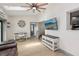 Bright living room with ceiling fan, skylight, modern desk and shelving, and light wood flooring at 1360 Gladiolas Dr, Winter Park, FL 32792