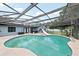 Sparkling pool with a slide and hot tub within a screened enclosure, creating a backyard oasis at 1360 Gladiolas Dr, Winter Park, FL 32792