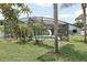 Enclosed pool with slide and patio furniture surrounded by lush tropical landscaping, creating a private retreat at 1360 Gladiolas Dr, Winter Park, FL 32792