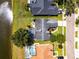 Aerial view featuring a screened pool and a lush backyard that overlooks a lake at 14377 Lord Barclay Dr, Orlando, FL 32837