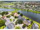 Picturesque view of a residential neighborhood featuring peaceful lakes, and lush green landscaping at 14377 Lord Barclay Dr, Orlando, FL 32837