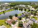 Aerial view of a lovely community showcasing the tranquil lake, lush greenery, and well-maintained homes at 14377 Lord Barclay Dr, Orlando, FL 32837