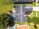 An overhead view of a house that features a screened-in pool, an outdoor seating area, and a beautiful landscape at 14377 Lord Barclay Dr, Orlando, FL 32837