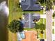 An overhead view of a house that features a screened-in pool, an outdoor seating area, and a beautiful landscape at 14377 Lord Barclay Dr, Orlando, FL 32837