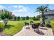 The landscaped backyard features a brick patio with comfortable seating and a fire pit, perfect for outdoor gatherings and relaxation at 14377 Lord Barclay Dr, Orlando, FL 32837