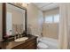 A traditional bathroom with a beautiful vanity, a large mirror, and a combined shower and tub is the perfect way to wind down at 14377 Lord Barclay Dr, Orlando, FL 32837