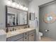 Bathroom featuring a double vanity, a large mirror, and a separate toilet room at 14377 Lord Barclay Dr, Orlando, FL 32837